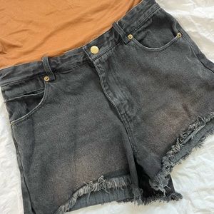 New faded black denim shorts with fringe and worn gold button